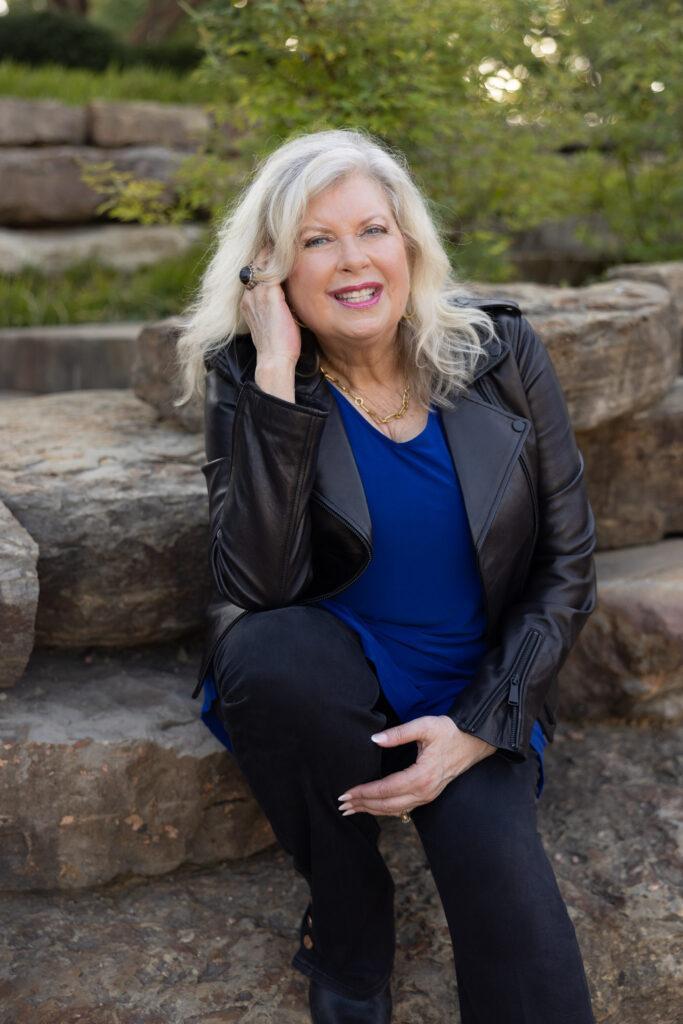 Carol Speed sitting on stones